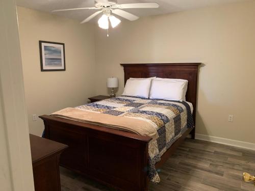 a bedroom with a bed with a ceiling fan at Bill’s On Little Pigeon River in Pigeon Forge