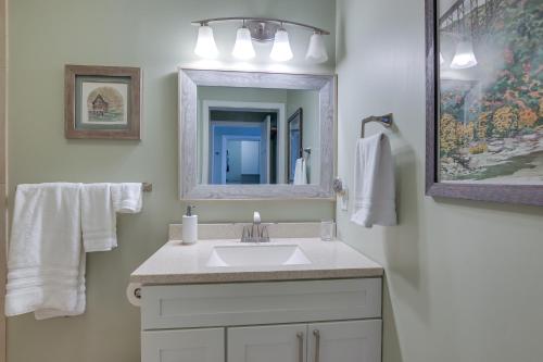 a bathroom with a white sink and a mirror at Lakefront Radford Home with Wraparound Deck! in Radford