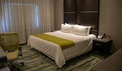 um quarto de hotel com uma cama e uma cadeira em Hotel Araiza San Luis R.C. em San Luis Río Colorado