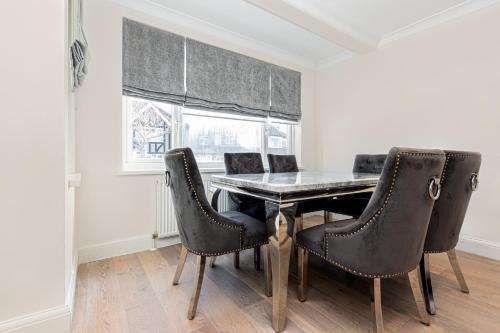 a dining room with a table and chairs at Gardened 2BR house, quiet Cul-de-Sac of Wembley in Preston