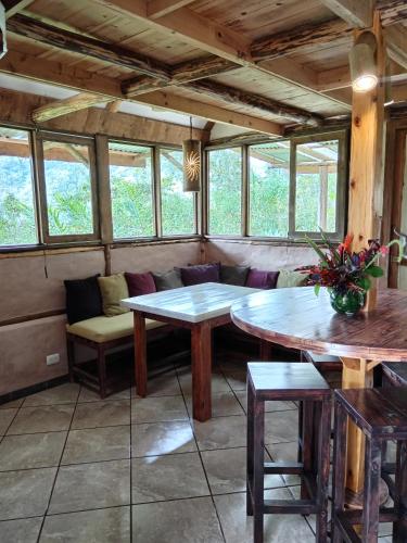 a room with a couch and tables and windows at La Cima del Mundo in Chimirol