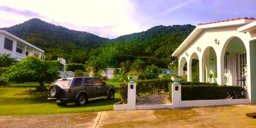 a car parked in front of a house at Beautiful House With Gazeebo Close to Beach in Ceiba