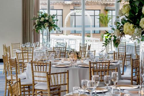 a table set up for a wedding with white tables and chairs at Hyatt Regency Saint Louis at The Arch in Saint Louis
