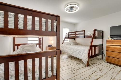 a bedroom with two bunk beds and a tv at Waterfront Haven Padre Island Home with Swim Spa! in Padre Island