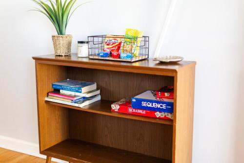 a book shelf with books and a potted plant at Fantastic 3BR Close to Botanical Gardens and Airport in Norfolk