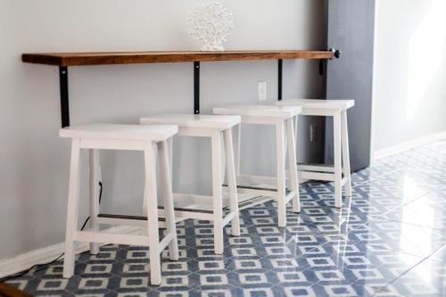 two white stools in a room with a table at Fantastic 3BR Close to Botanical Gardens and Airport in Norfolk