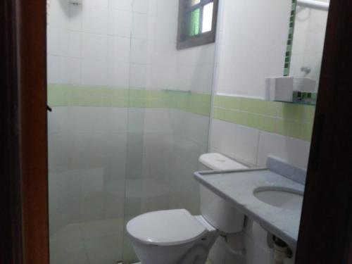 a bathroom with a toilet and a sink at Pousada Água Marinha in Caraguatatuba