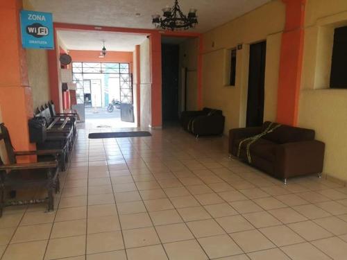 a living room with couches and a tile floor at Hotel Madrid Guadalajara in Guadalajara