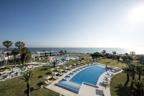 an aerial view of a resort with a swimming pool and the ocean at Iberostar Selection Diar El Andalous in Port El Kantaoui