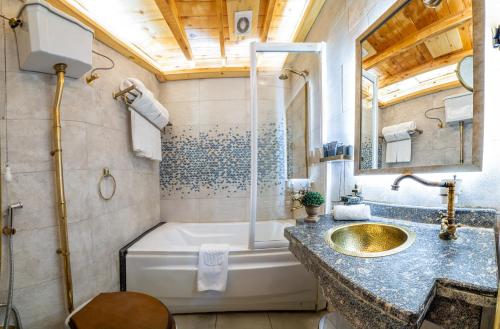 a bathroom with a tub and a sink and a shower at Sonesta Nouba Hotel Aswan in Aswan