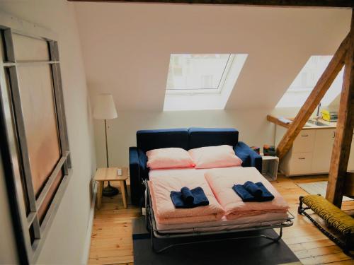 a bedroom with a bed with two pillows on it at Cityhouse Nauwies in Saarbrücken
