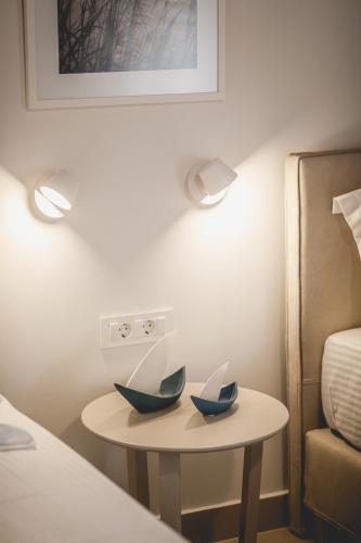 a table with two paper boats on it next to a bed at Votsalo Tolo in Tolo