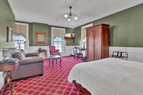 a bedroom with a bed and a living room at St James Hotel in Red Wing