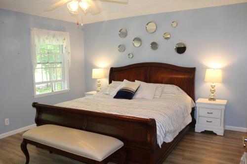 a bedroom with a bed and a chair and two lamps at Alpine Oasis - House in the Adirondacks close to Lakes, Golf, Skiing and so much more! 