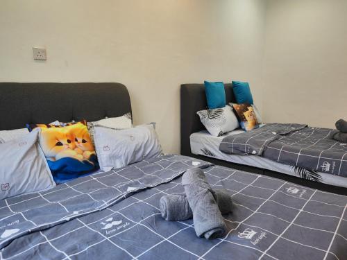 Кровать или кровати в номере Cozy Roomstay Padang Serai