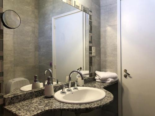 a bathroom with two sinks and a mirror at CASA GRANDE in Mendoza