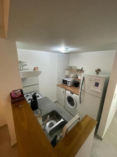 a small kitchen with a sink and a refrigerator at Alquiler temporal 51 in La Plata