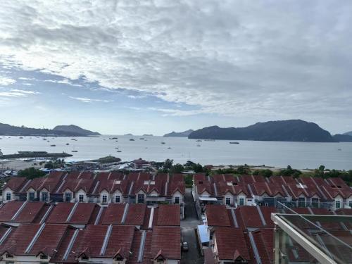 an aerial view of a city with houses and the water at Homestay Pangsapuri Simfoni 3BR 7Pax Kuah Langkawi in Kuah