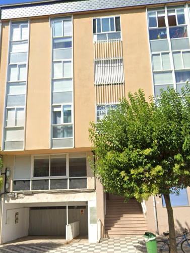 a building with a garage in front of it at DÚPLEX DUQUESA in O Barco de Valdeorras