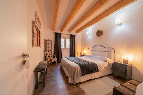a bedroom with a bed and a chair in a room at Quinta da Cris (Private Beach Retreat) in Costa Nova
