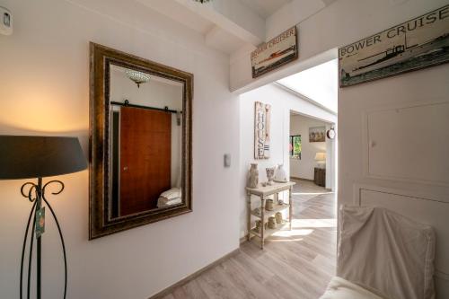 a mirror on the wall of a room with a couch at Quinta da Cris (Private Beach Retreat) in Costa Nova