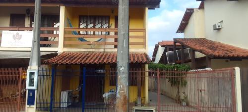 a building with a blue gate in front of it at Hospedaria Meu Lar in Rio das Ostras