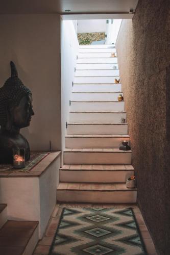 a stairway with a statue of a bust on the floor at Monte Do Malhao - Art, Eco & Spa in Castro Marim