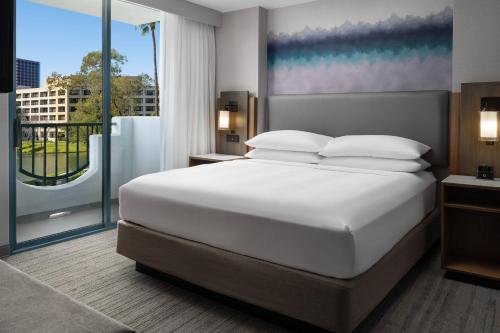 a bedroom with a large bed and a large window at Costa Mesa Marriott in Costa Mesa