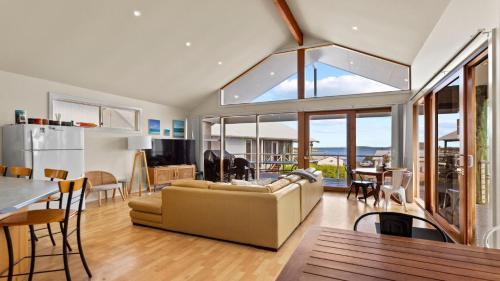 a living room with a couch and a table at Sheoak Holiday Home in Coffin Bay