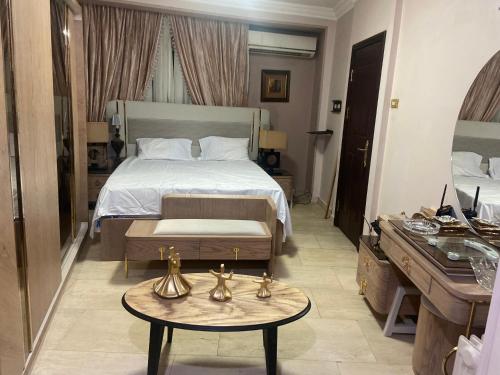 a hotel room with a bed and a table and a sink at Apartment for rent Zamalek in Cairo