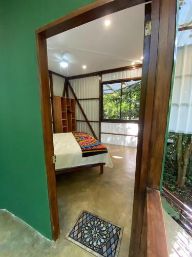 a bedroom with a bed in a room with a window at Peaceful Jungle Villa Kona - Pool & Parking for 2 persons in Puerto Viejo