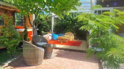 a patio with trees and a table and a rug at Delightful 1 bedroom tiny house, with retro Poptop in Westport