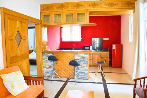 a kitchen with red walls and a red refrigerator at Eden Holidays Resort- Poste Lafayette in Poste Lafayette
