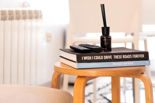 a stack of books sitting on top of a table at One of the Best Views Costa Nova III in Costa Nova
