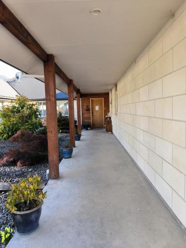 an empty hallway of a building with potted plants at Vibrant Living Retreat in Hanmer Springs