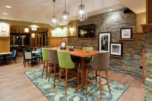 a dining room with a wooden table and chairs at Hampton Inn Duluth-Canal Park in Duluth