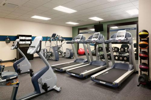 a gym with several treadmills and cardio machines at Hampton Inn & Suites - Mansfield in Mansfield