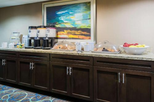 a buffet with bowls of food on a counter at Hampton Inn White Plains/Tarrytown in Elmsford