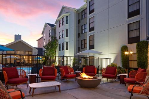 a patio with chairs and a fire pit in front of a building at Hampton Inn & Suites El Paso-Airport in El Paso