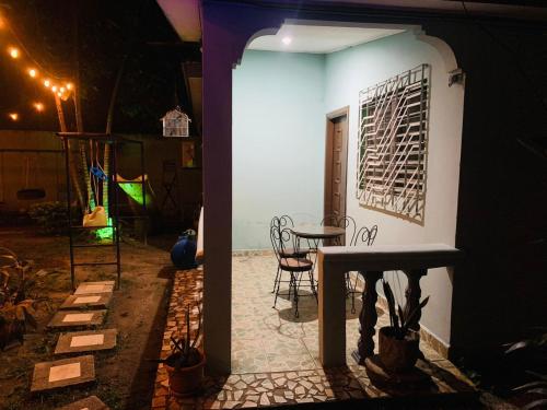 a house with a table and chairs in a yard at night at La Casita in San Pedro Sula