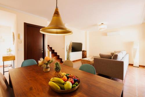 a bowl of fruit on a wooden table in a living room at La Tejita Ocean Villa in Granadilla de Abona
