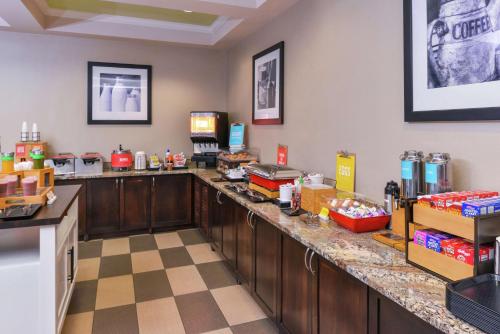 a restaurant with a counter with food on it at Hampton Inn Eugene in Eugene