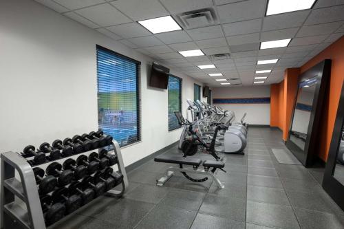a gym with a bunch of equipment in a room at Hampton Inn Evansville Airport in Evansville