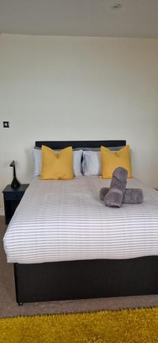 a bedroom with a large bed with yellow pillows at The Copper fields in London