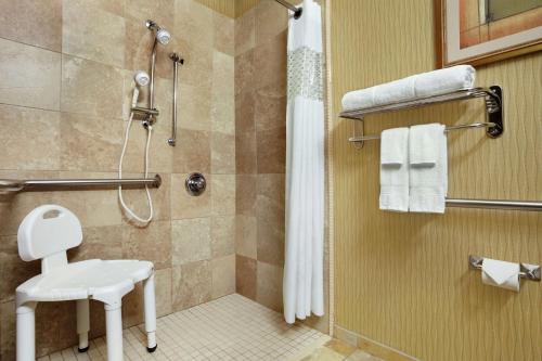 a bathroom with a shower with a toilet and a sink at Hampton Inn Findlay in Findlay