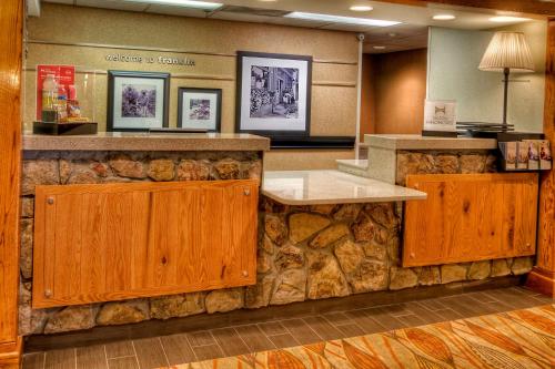 a lobby of a hotel with a stone counter at Hampton Inn Franklin, NC in Franklin