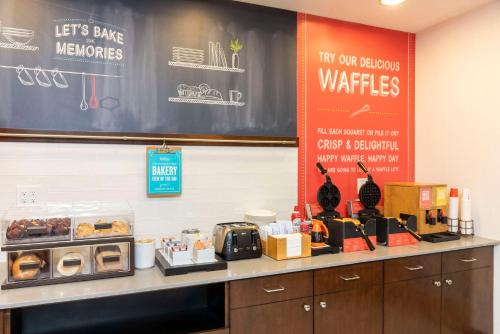 a counter with donuts and a chalkboard on the wall at Hampton Inn & Suites Fort Myers-Colonial Boulevard in Fort Myers