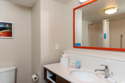 a bathroom with a sink and a mirror at Hampton Inn & Suites Fort Myers-Colonial Boulevard in Fort Myers