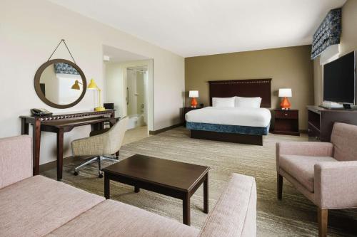 Hampton Inn & Suites Ft. Lauderdale/West-Sawgrass/Tamarac, FL في تاماراك: غرفة في الفندق مع سرير ومكتب