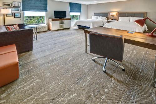 a hotel room with two beds and a desk at Hampton Inn & Suites Fort Myers Estero in Estero